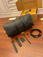 Louis Vuitton monogram duffle bag in dark gray with strap accessories laid out