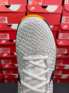 White outsole heel of athletic sneaker with circular traction pattern and white laces