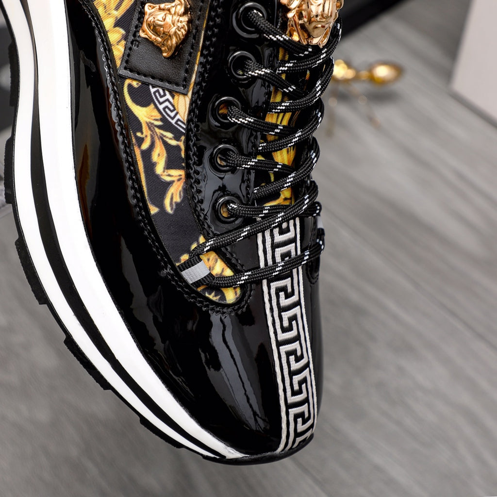 Versace black patent sneakers with gold lace accents and Greek key side stripe