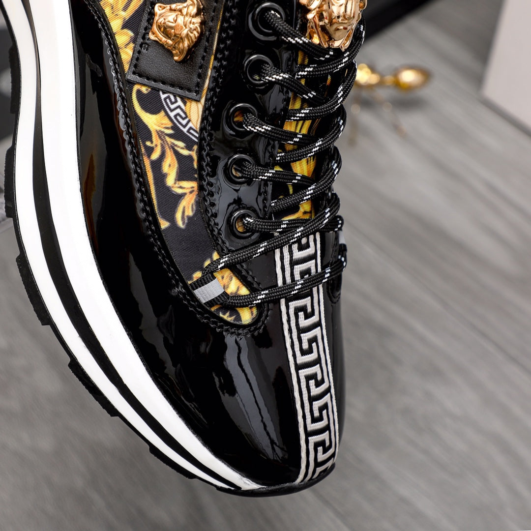 Versace black patent sneakers with gold lace accents and Greek key side stripe