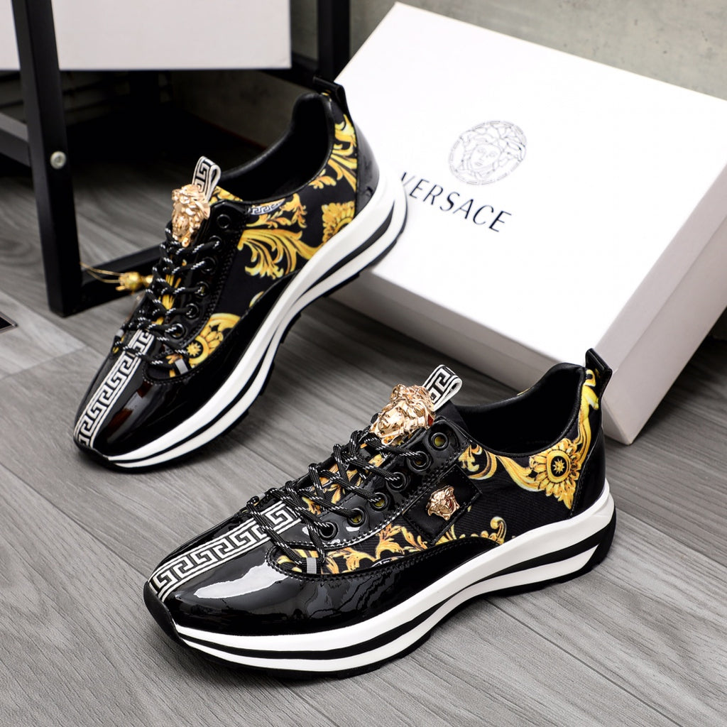 Versace black sneakers with gold baroque print, medallion accents, and white soles