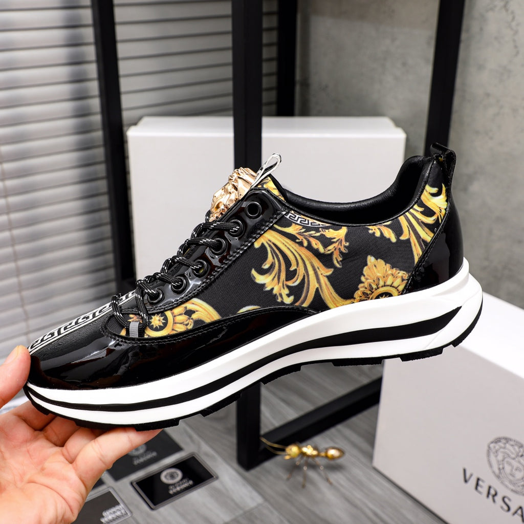 Versace black-and-gold sneakers with lion ornament, baroque trim, and white platform sole