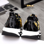 Versace black sneakers with gold baroque detailing and white midsoles