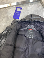 Black puffer jacket interior with brand label and care instructions