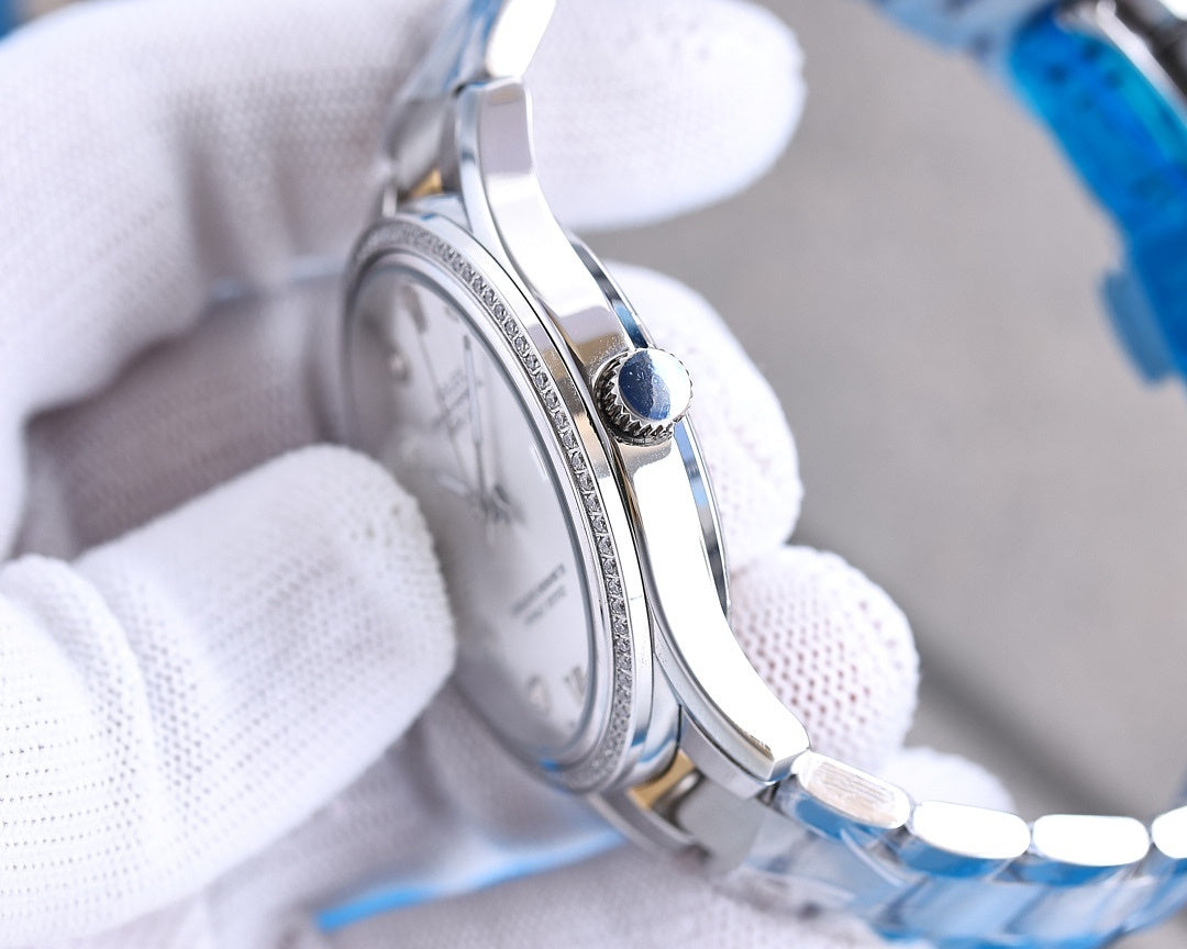 Stainless steel Rolex watch case side with crown detail and blue accent.