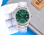 Stainless steel Rolex watch with green dial, Roman numerals, and date window at 3 o'clock.