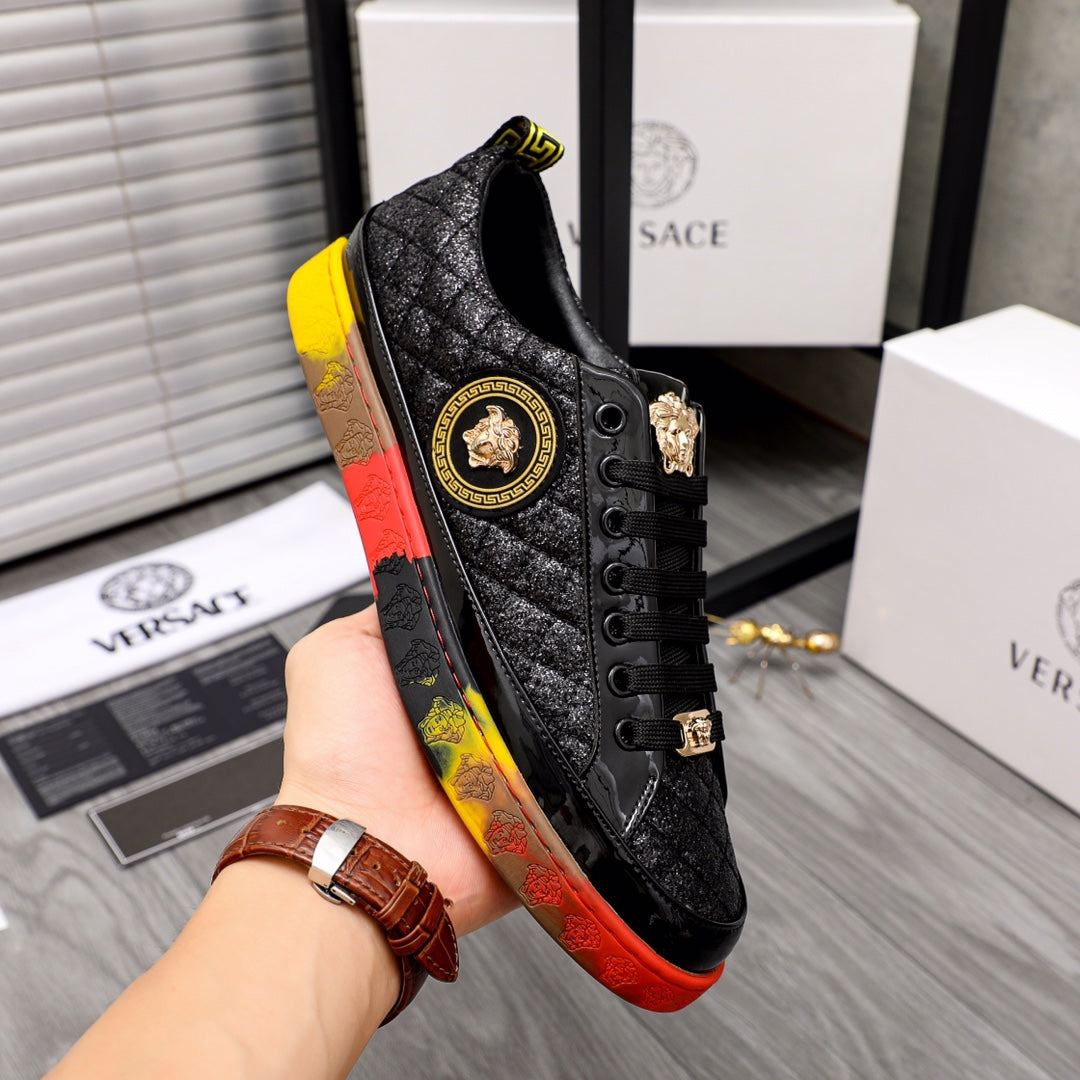 Black textured lace-up sneaker with gold crest patch and red/yellow outsole