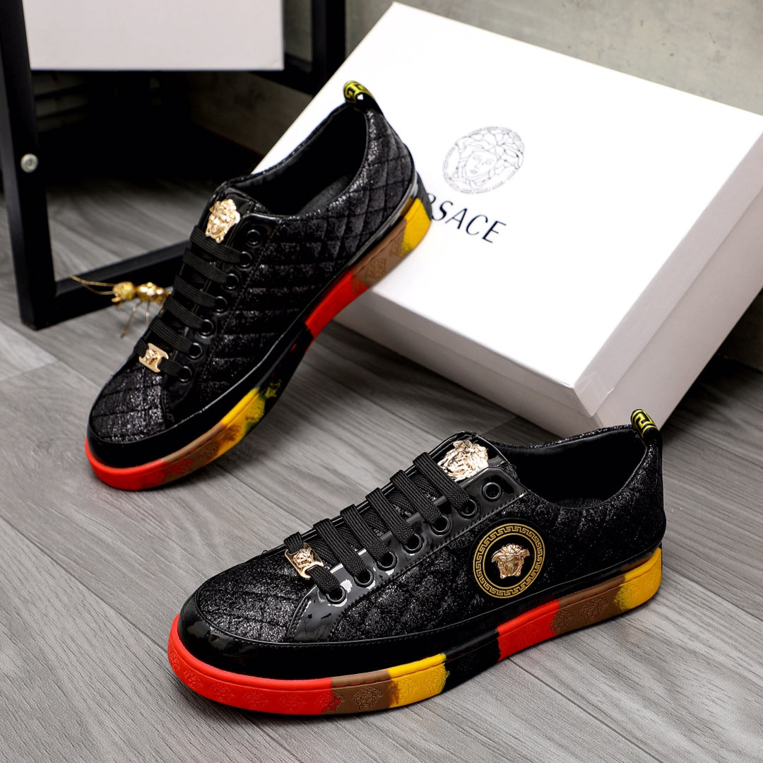 Versace black lace-up sneakers with gold emblem and red/yellow contrast sole