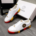 White quilted sneakers with gold lace charms, round emblem, and red-yellow rubber sole