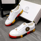 White quilted sneakers with gold lace charms, round emblem, and red-yellow rubber sole