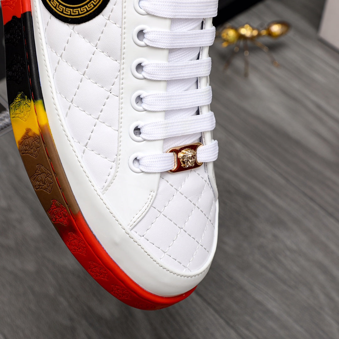 White quilted sneaker with gold lace charm and white laces over red-yellow sole