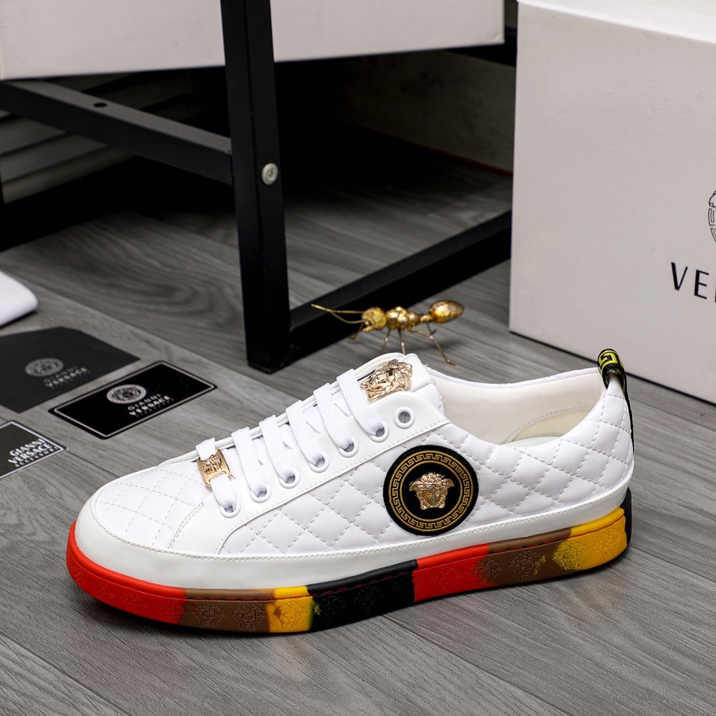 White quilted sneakers with gold emblem patch, decorative lace charms, and red-yellow sole
