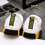White quilted sneakers with Greek-style trim on heel and red-yellow rubber sole