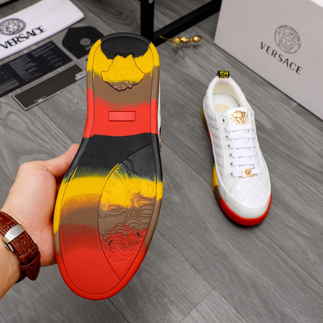 Red and yellow sneaker outsole with black and gold graphic; white upper with gold details