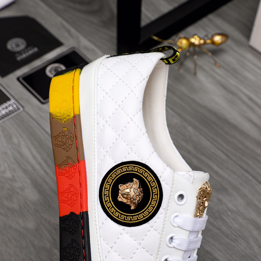 White quilted sneakers with round gold emblem, gold-threaded heel, and red-yellow sole