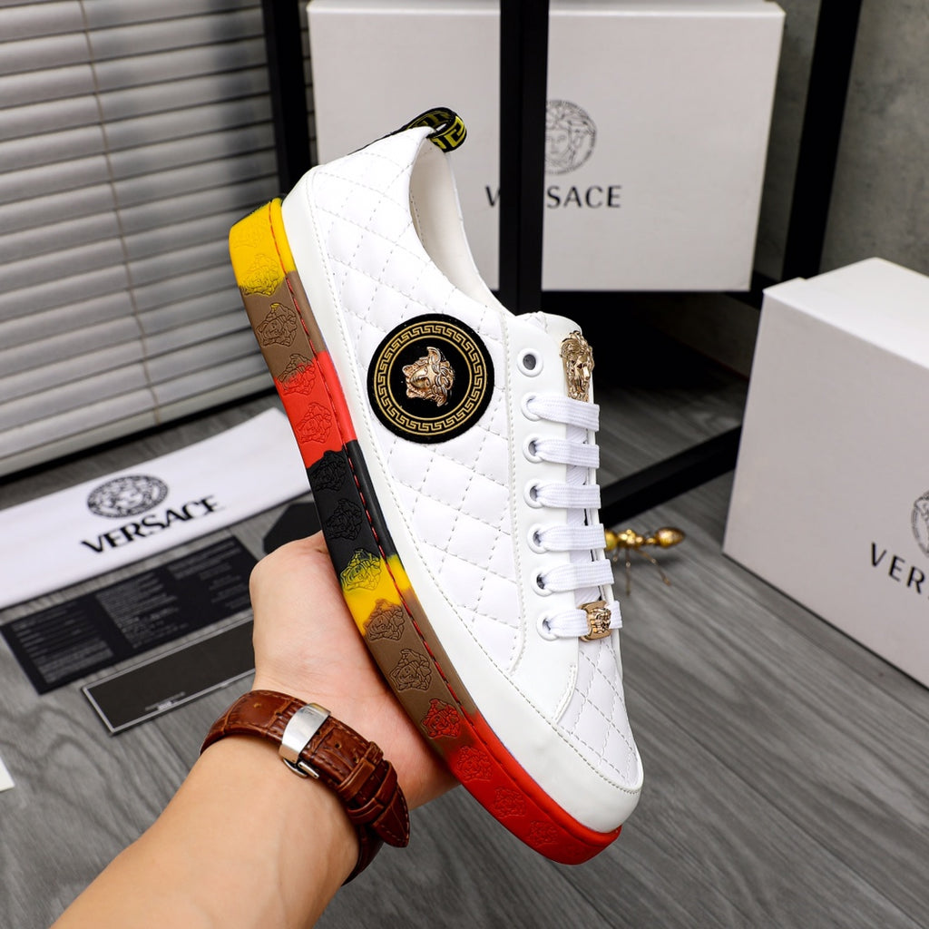 White quilted high-top sneakers with gold side emblem, gold lace charm, red-yellow sole