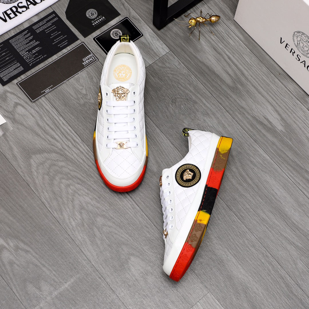 Pair of white quilted sneakers with gold details and red-yellow rubber soles