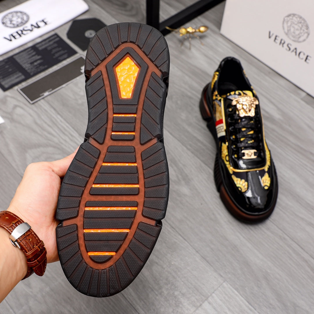 Versace luxury sneakers outsole and side, textured dark tread with orange center pattern.