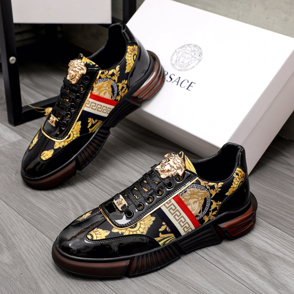 Versace luxury sneakers, black patent, gold logo accents, red/white stripe.