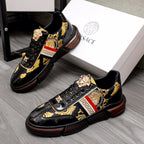Versace luxury sneakers, black patent, gold logo accents, red/white stripe.