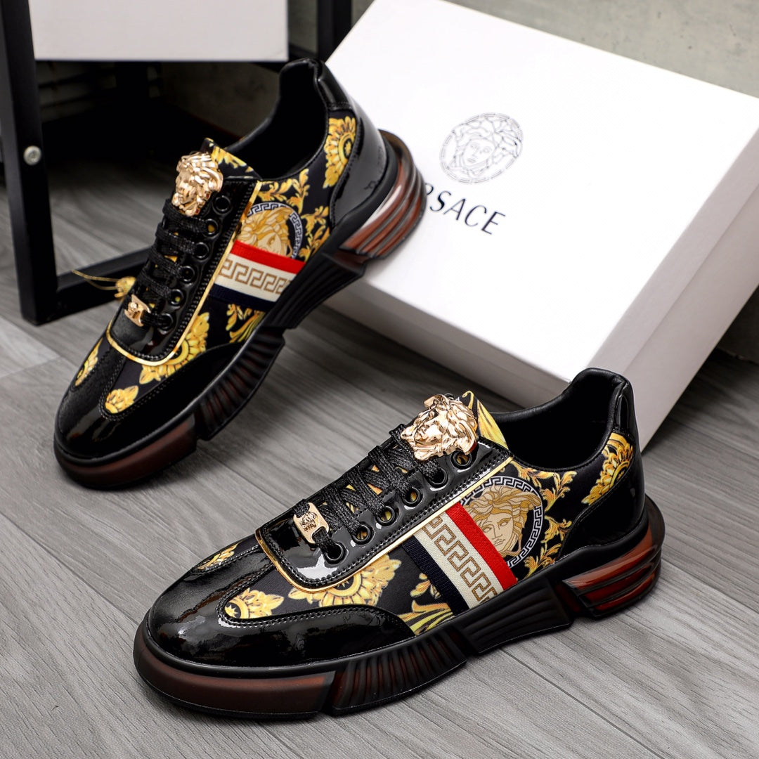 Versace luxury sneakers, black patent, gold logo accents, red/white stripe.