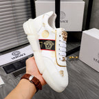 Versace white sneakers with gold heel emblem, logo stripe panel, and padded sole