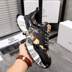 Black Versace sneakers with baroque print lining, chunky white sole, decorative gold crest