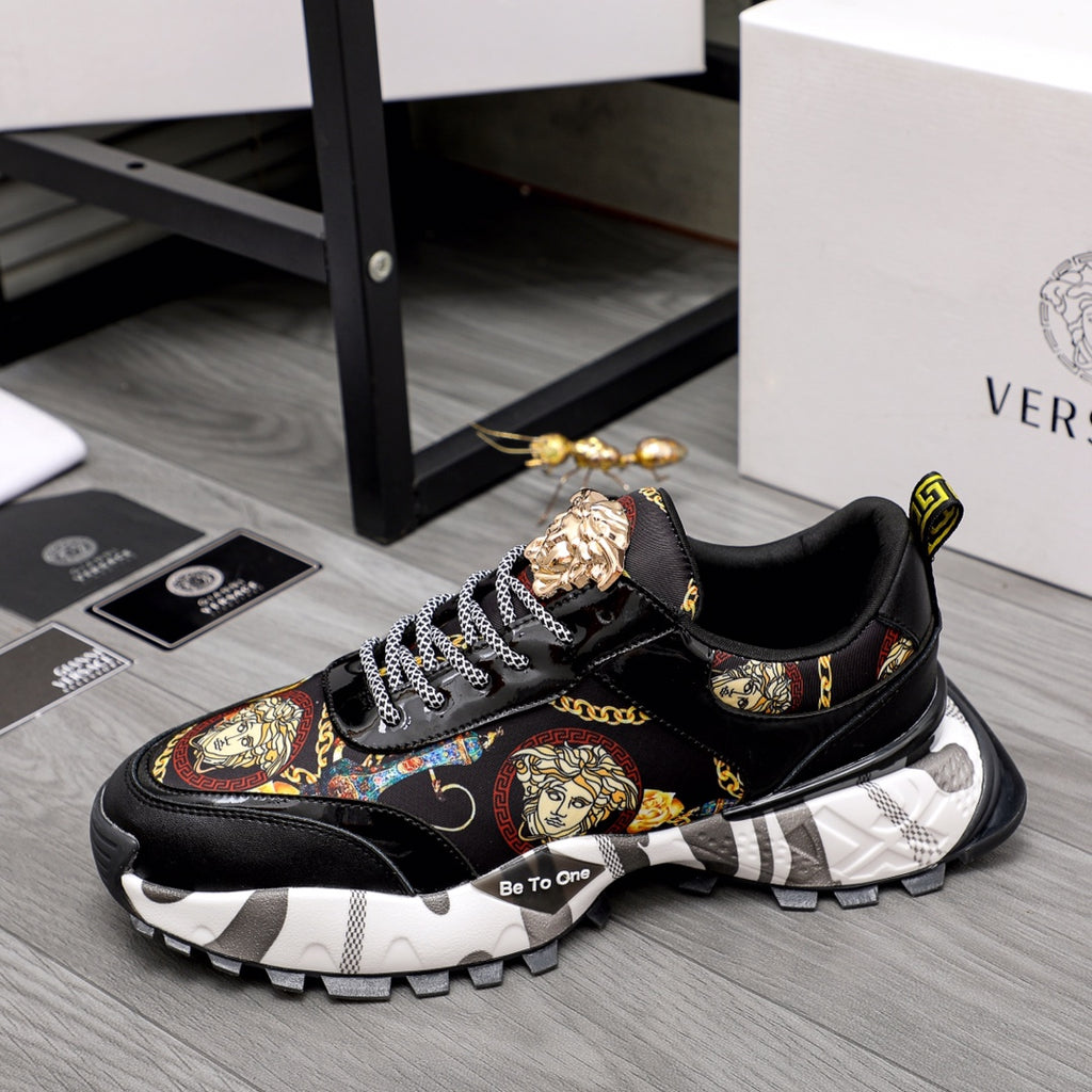 Black lace-up sneakers with baroque graphic panel, gold crest details, chunky tread sole