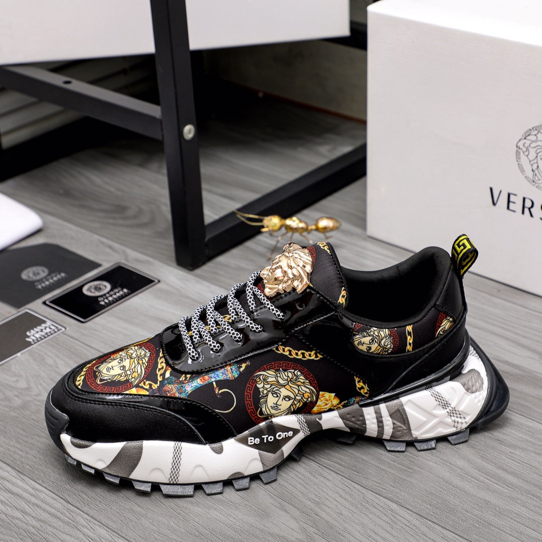 Black lace-up sneakers with baroque graphic panel, gold crest details, chunky tread sole