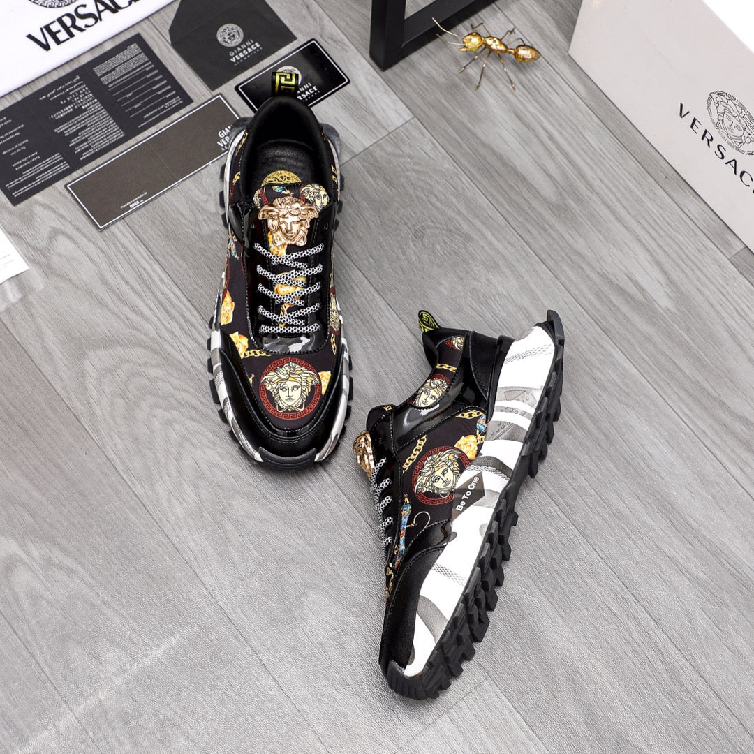 Pair of black Versace sneakers with baroque medallion accents and checker lace-up design