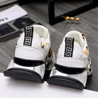 Back view of white sneakers with Greek key trim, gold emblem, and black sole