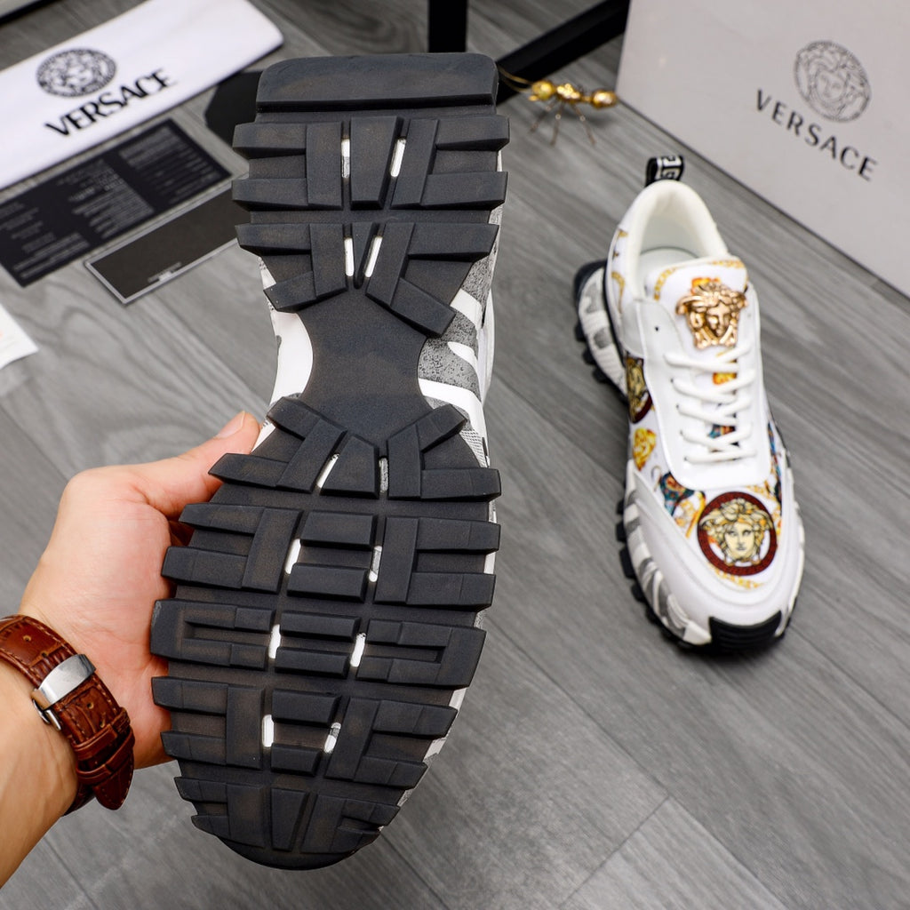 Outsole view of chunky black sneaker sole with grid tread and white upper