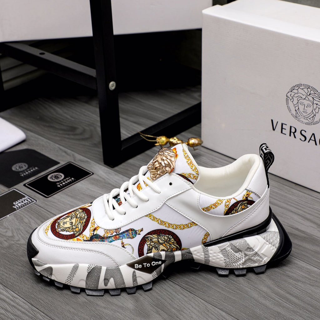 White low-top sneakers with gold Medusa hardware, patterned side panel, chunky sole