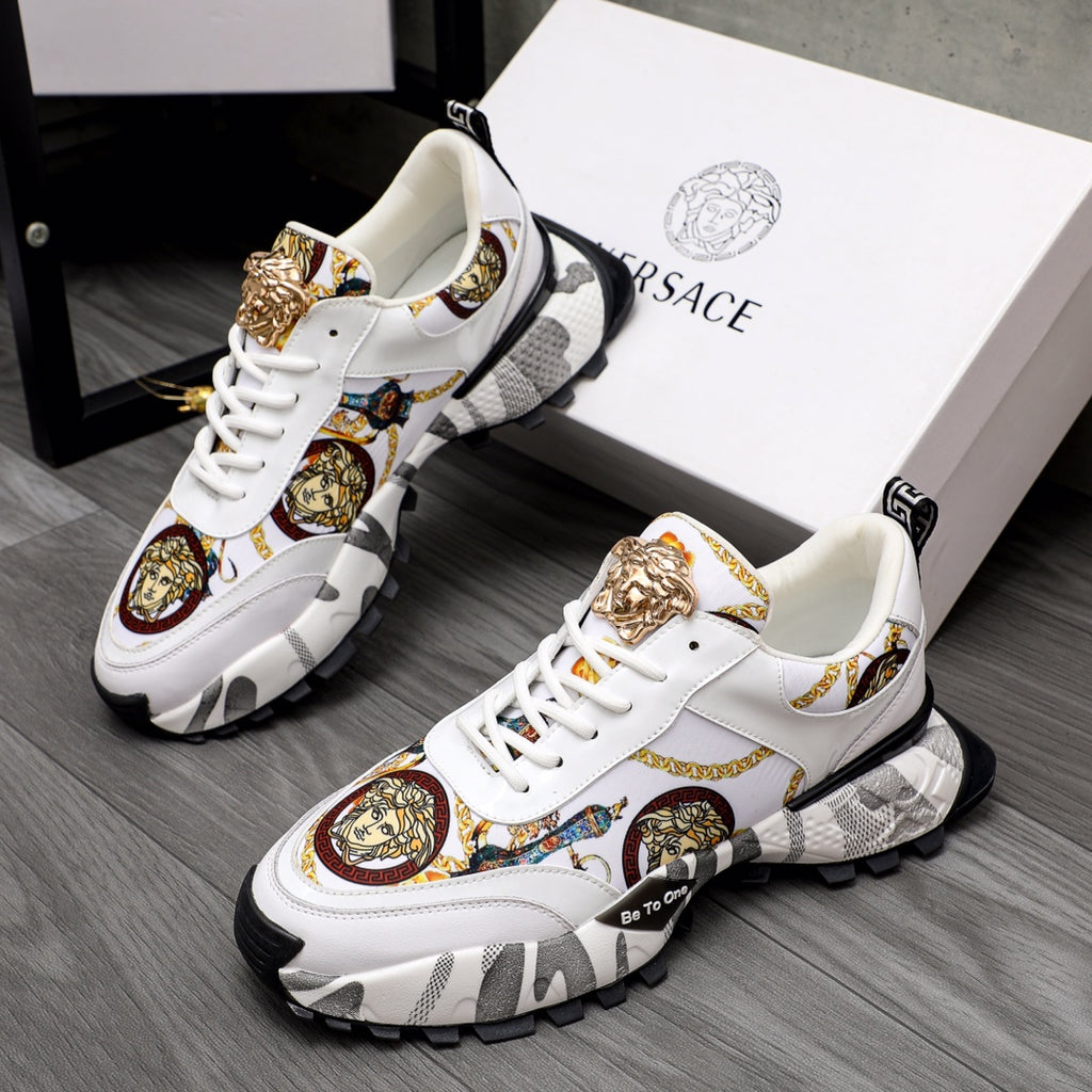 White sneakers with gold Medusa detail, patterned panels, and chunky black sole