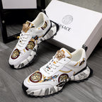 White sneakers with gold Medusa detail, patterned panels, and chunky black sole