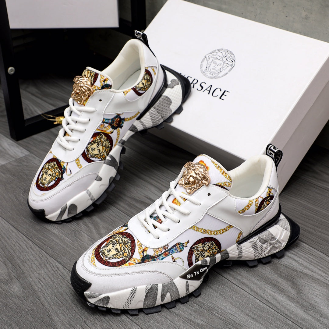 White sneakers with gold Medusa detail, patterned panels, and chunky black sole