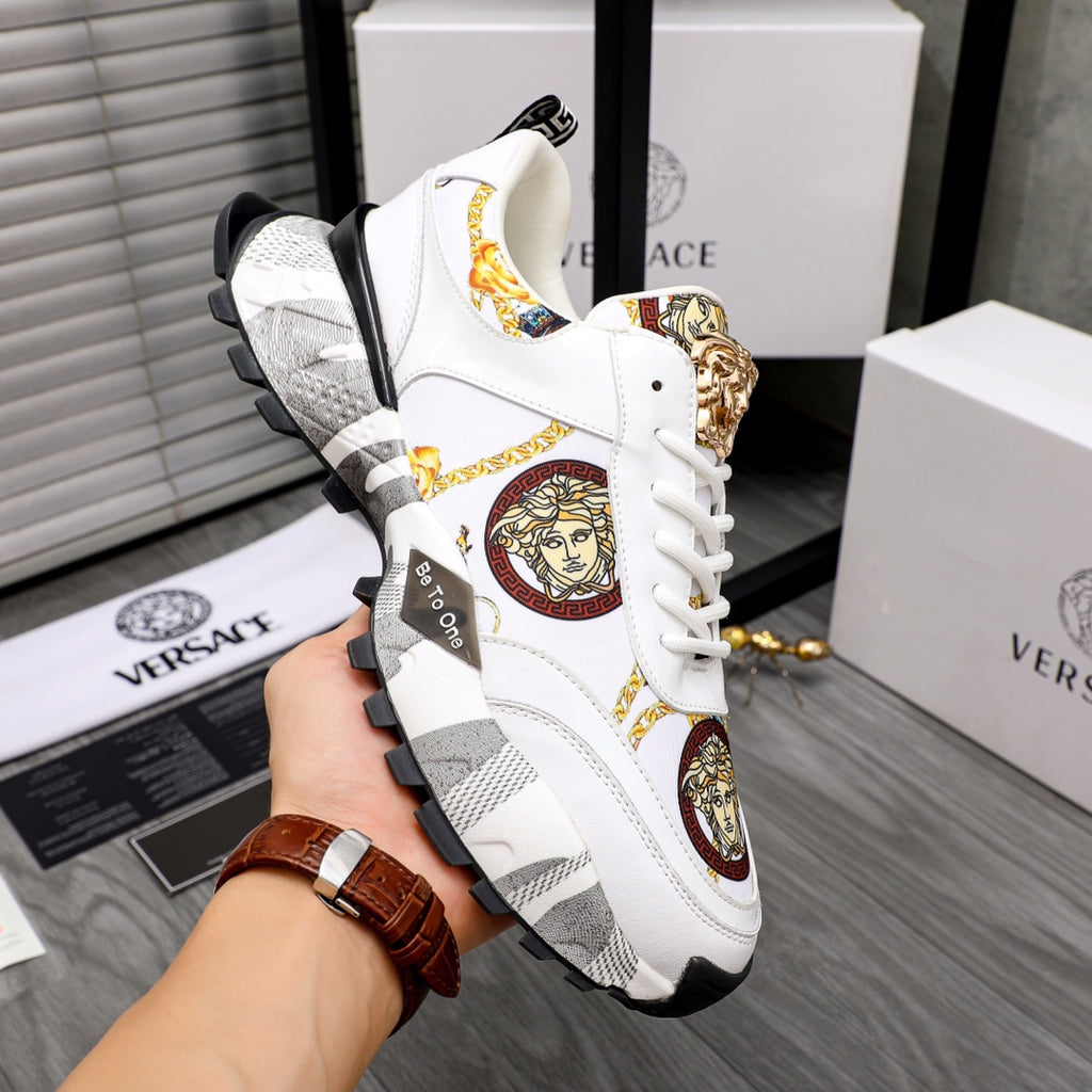 White sneakers with gold Medusa badge, colorful emblem accents, chunky gray sole