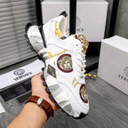 White sneakers with gold Medusa badge, colorful emblem accents, chunky gray sole
