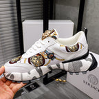 White sneakers with gold Medusa ankle detail, patterned side stripe, thick sole