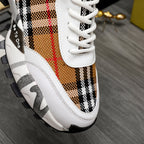 Burberry sneaker close-up: white laces, plaid quarter panel, Be to go tag