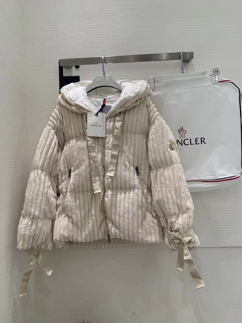 Cream long puffer jacket with hood, full zipper, and ribbed quilted texture