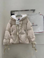Cream long puffer jacket with hood, full zipper, and ribbed quilted texture