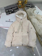 Cream hooded long puffer jacket with front zipper and small chest emblem