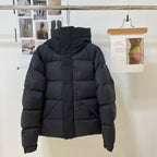 Black long puffer jacket with hood, front zipper and quilted paneling