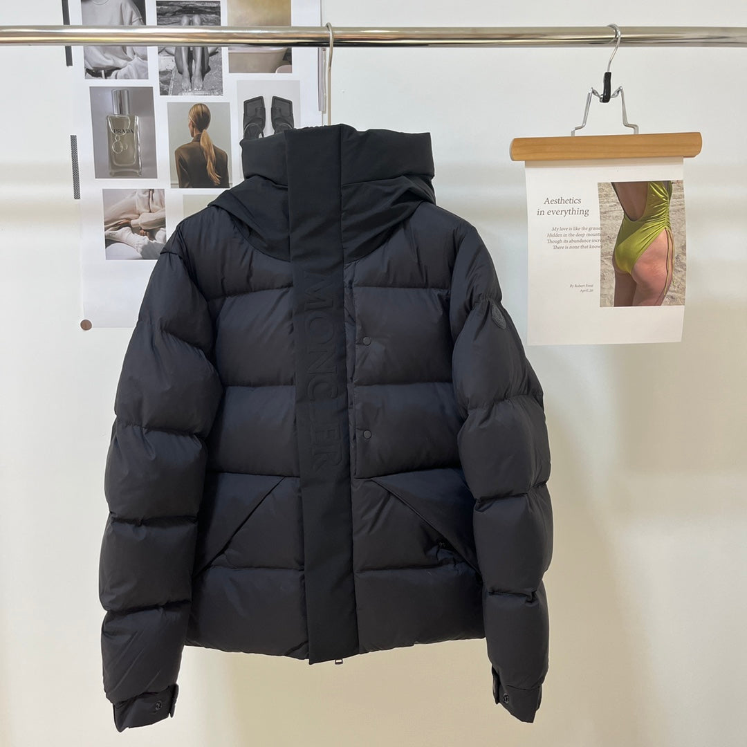 Black long puffer jacket with hood, front zipper and quilted paneling