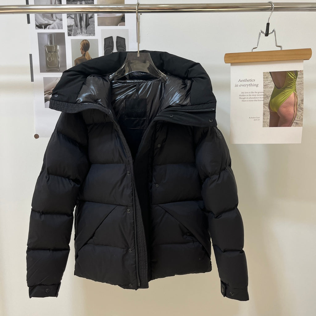 Black long puffer jacket with hood and quilted front with zipper