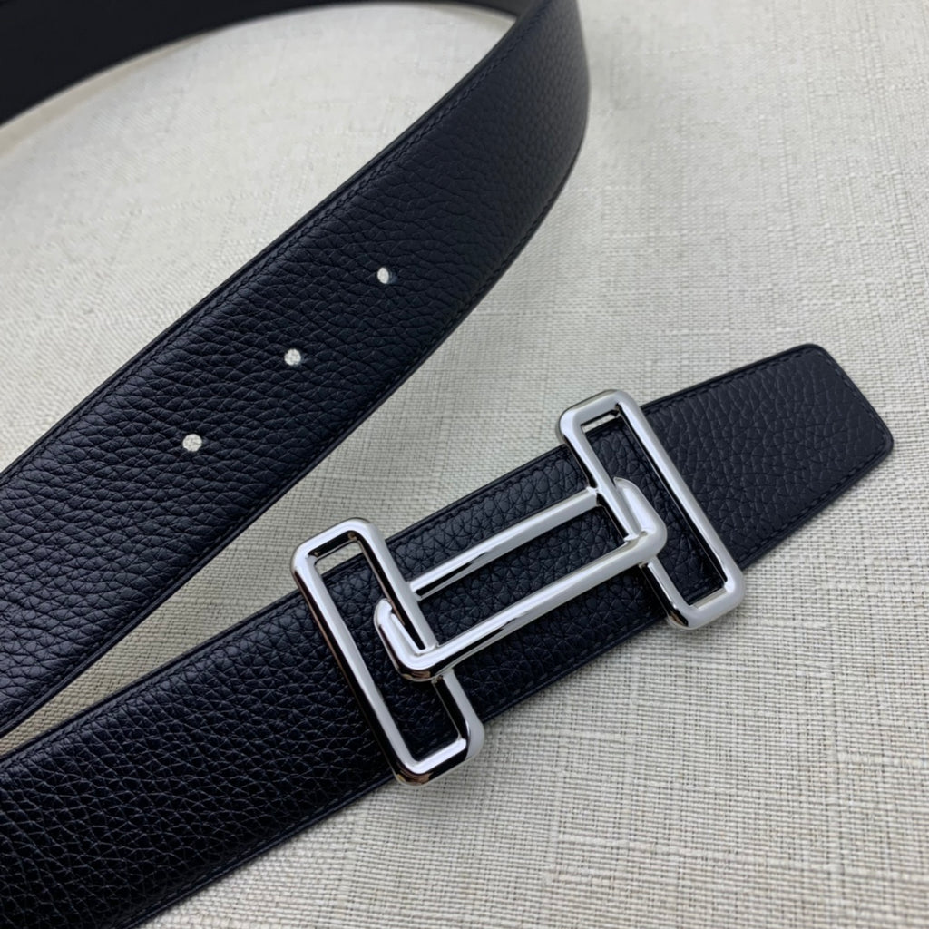 Leather belt with dark navy grain texture, silver-tone double H buckle and punched holes.