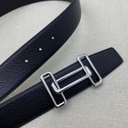 Leather belt with dark navy grain texture, silver-tone double H buckle and punched holes.