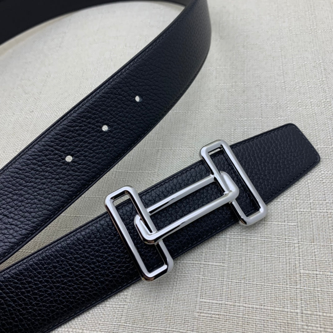 Leather belt with dark navy grain texture, silver-tone double H buckle and punched holes.