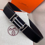 Leather belt with dark navy grain texture and silver-tone double H buckle, side view.